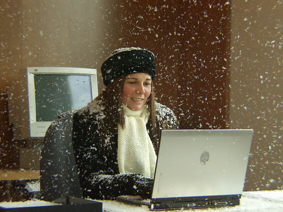 Actor sitting at desk in snowstorm